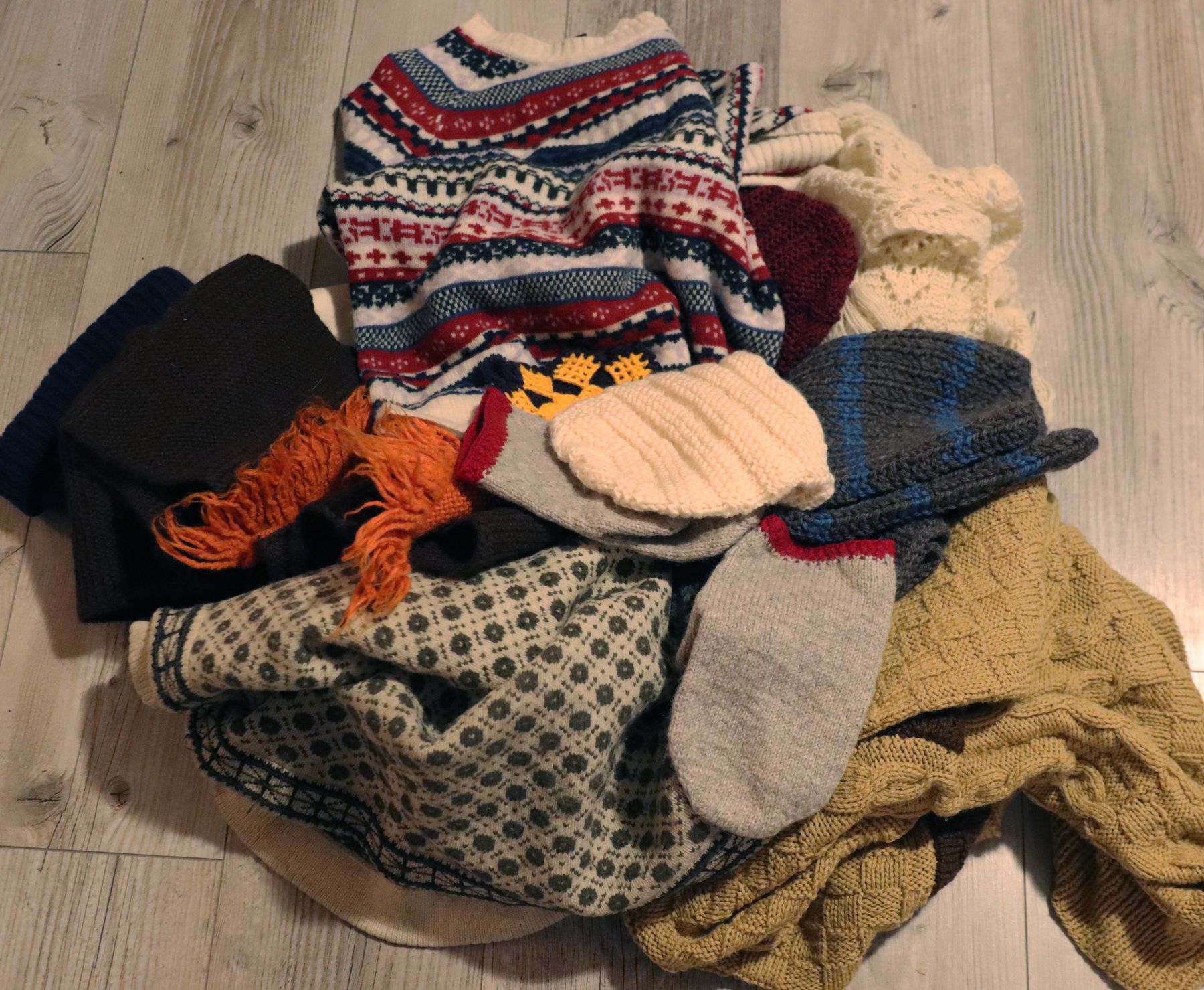 pile of used woollen clothes