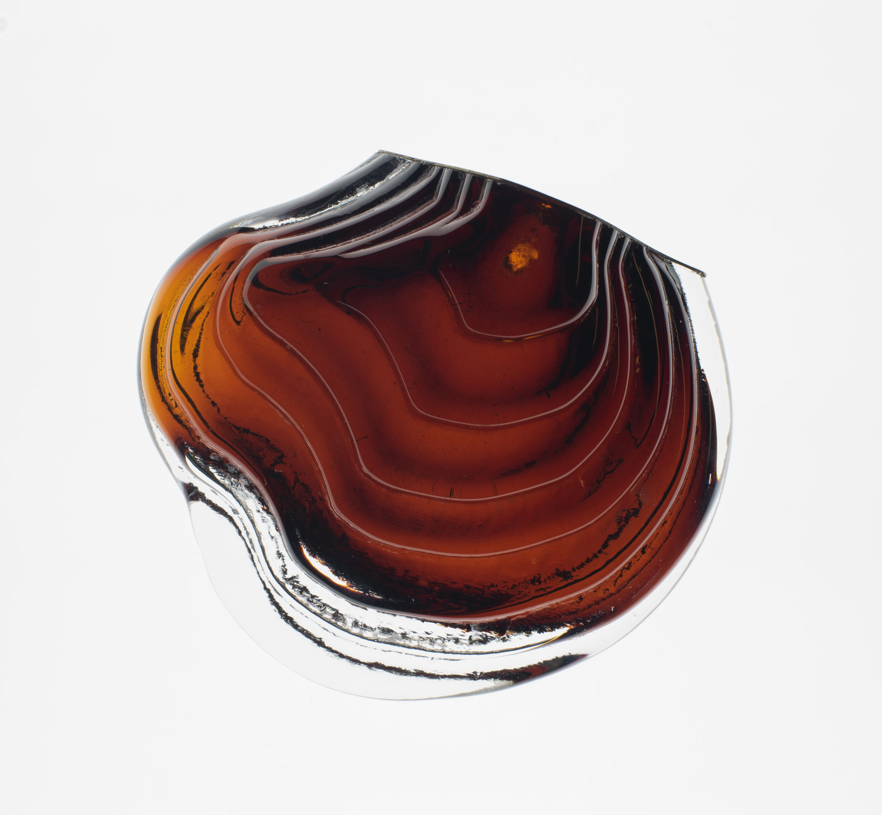 a transparent and red coloured glass piece shaped like a polypore