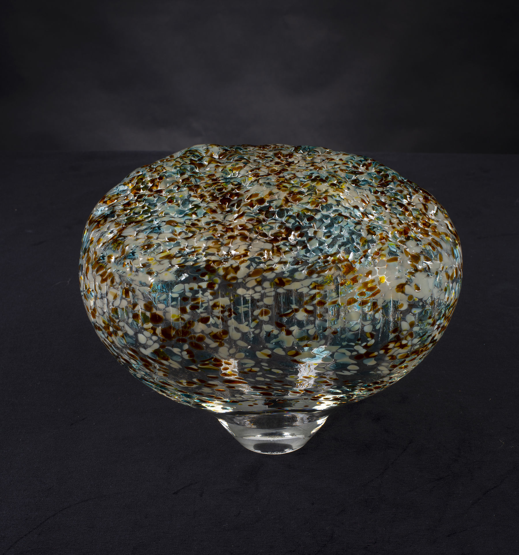 an organic shaped glass sculpture with colors