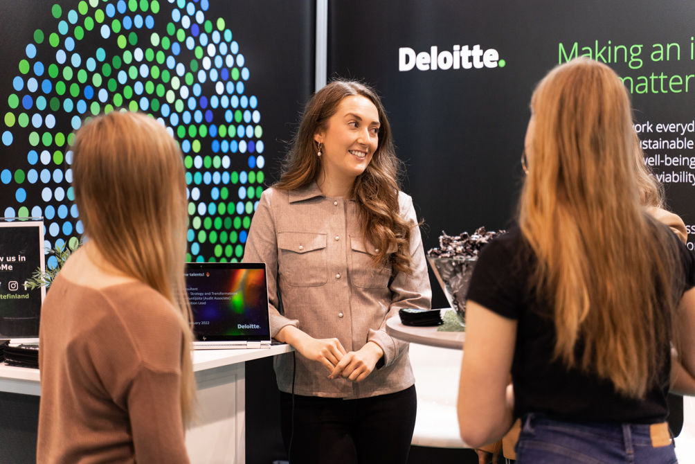Woman from Deloitte discussing with students