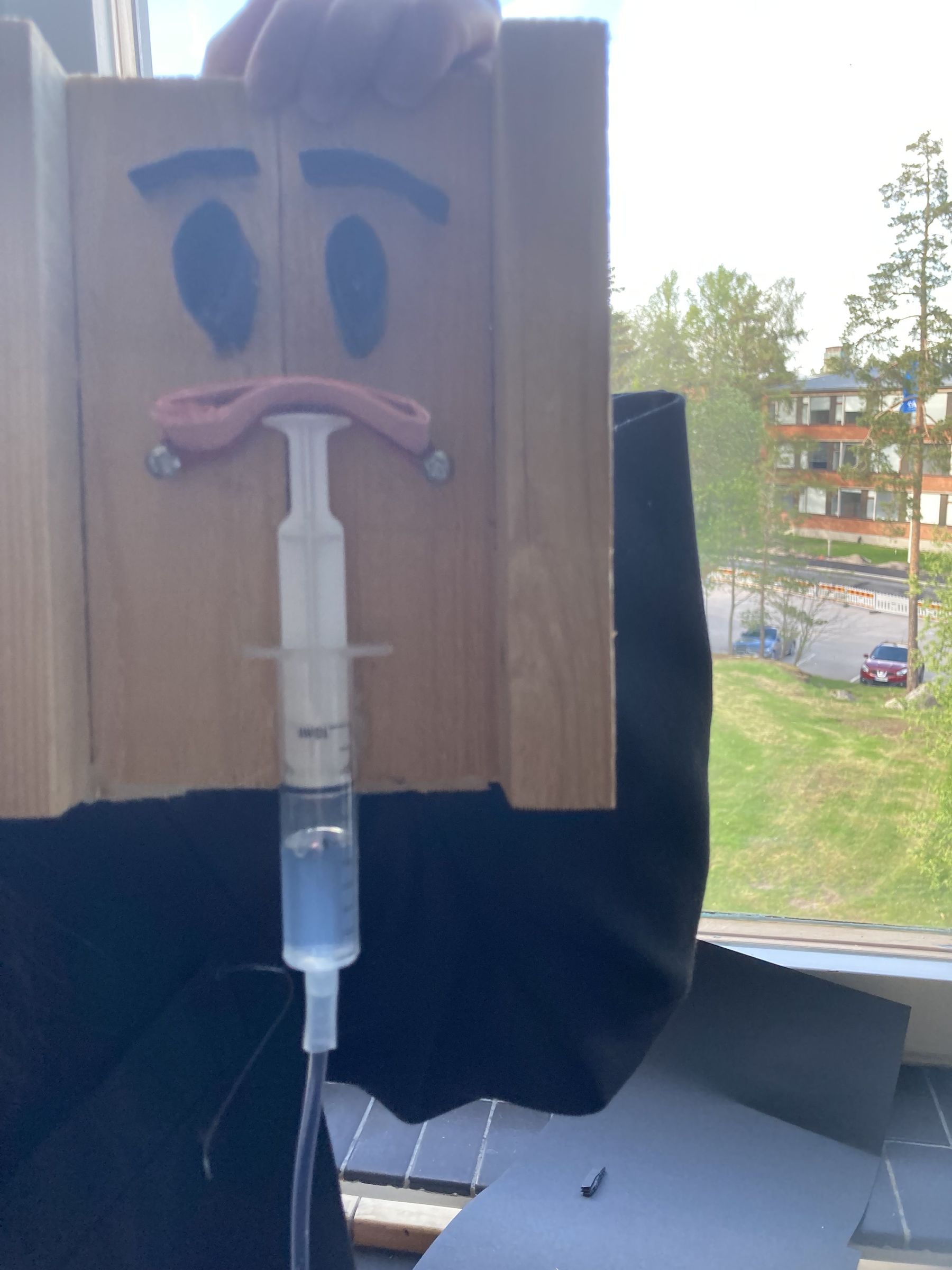 Syringe with a smiley face.