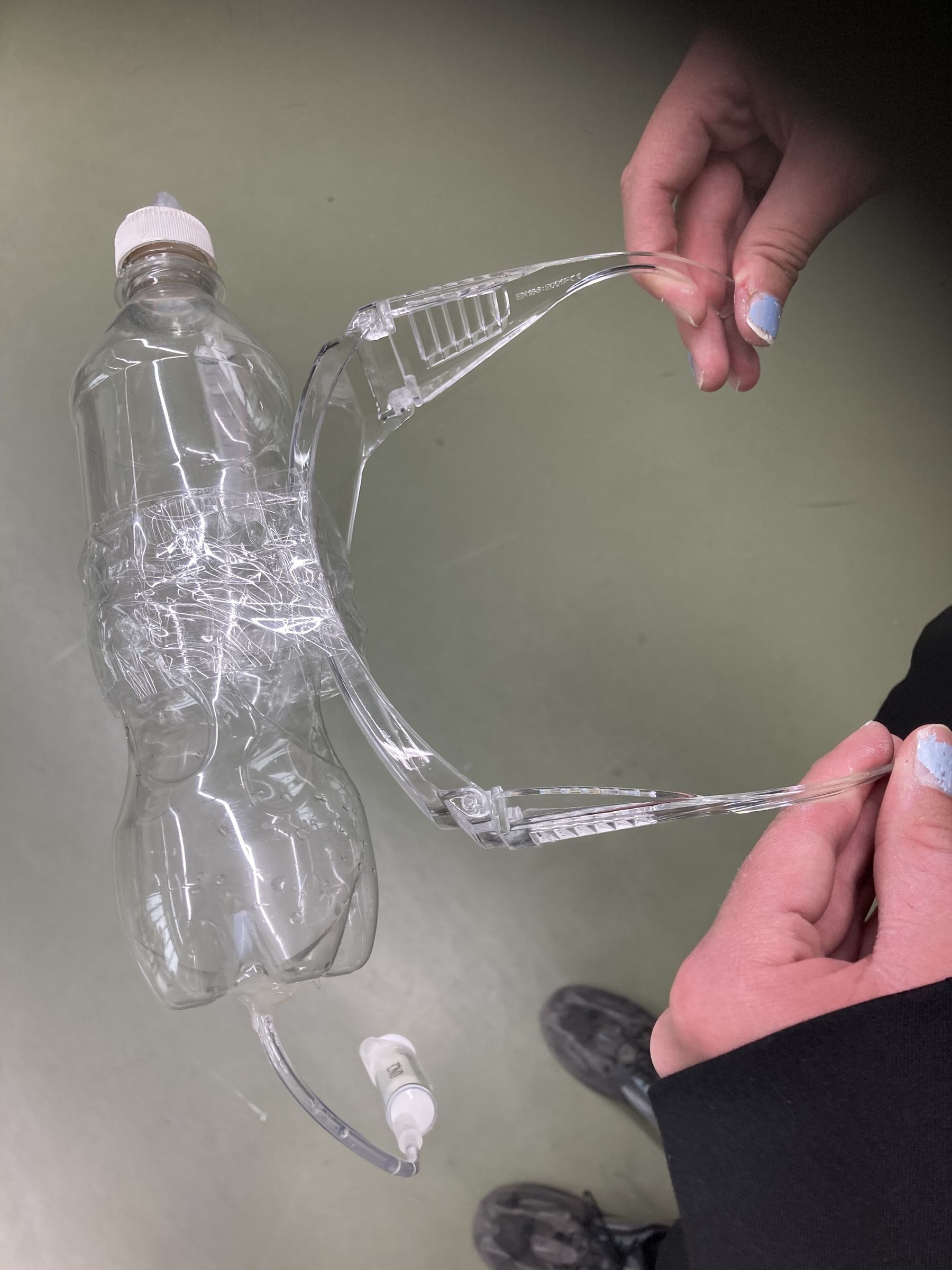 Water bottle taped onto plastic glasses.