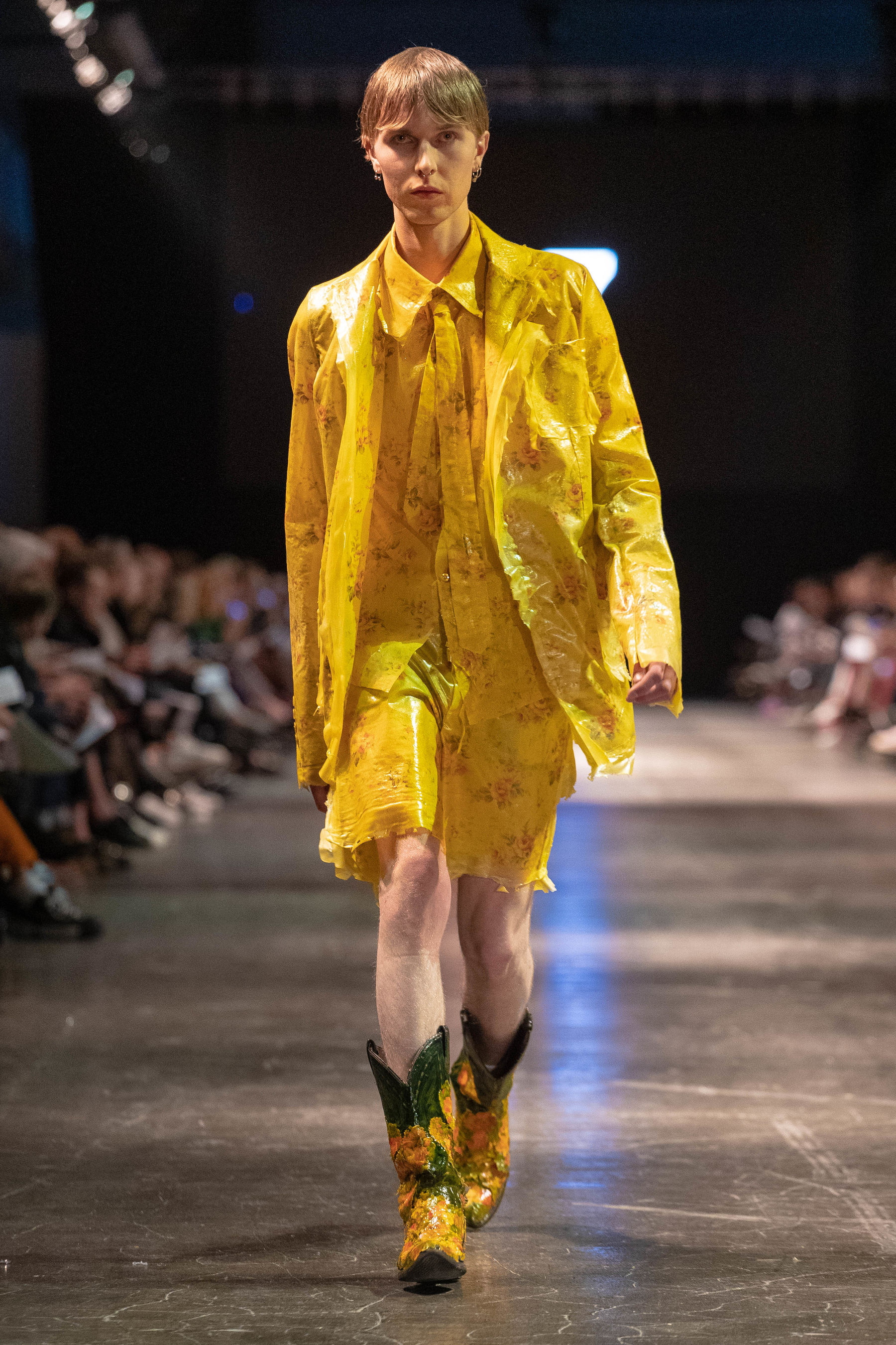 model on runway in yellow suit with shorts