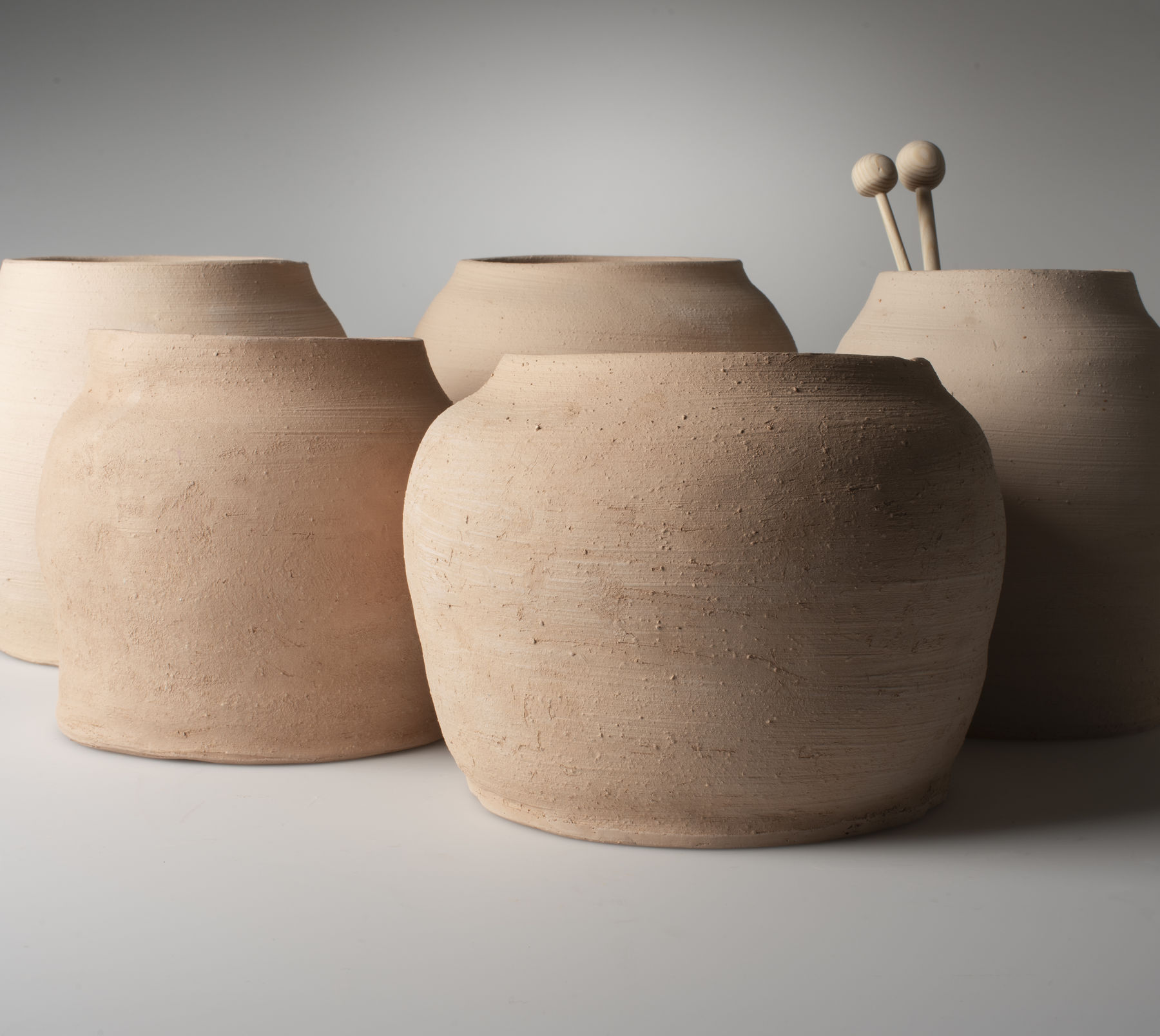 a close-up of five ceramic pots