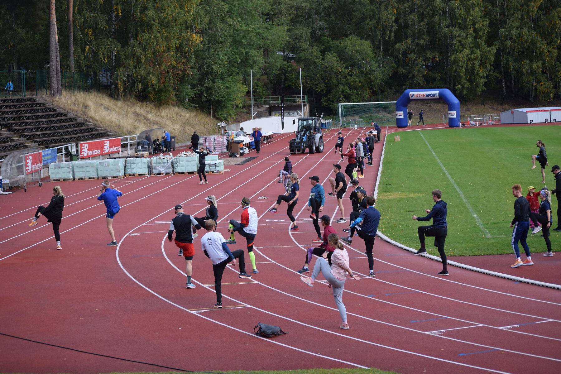 People stretching and warming up in sports track for Aalto 10K & 5K event in September 2022