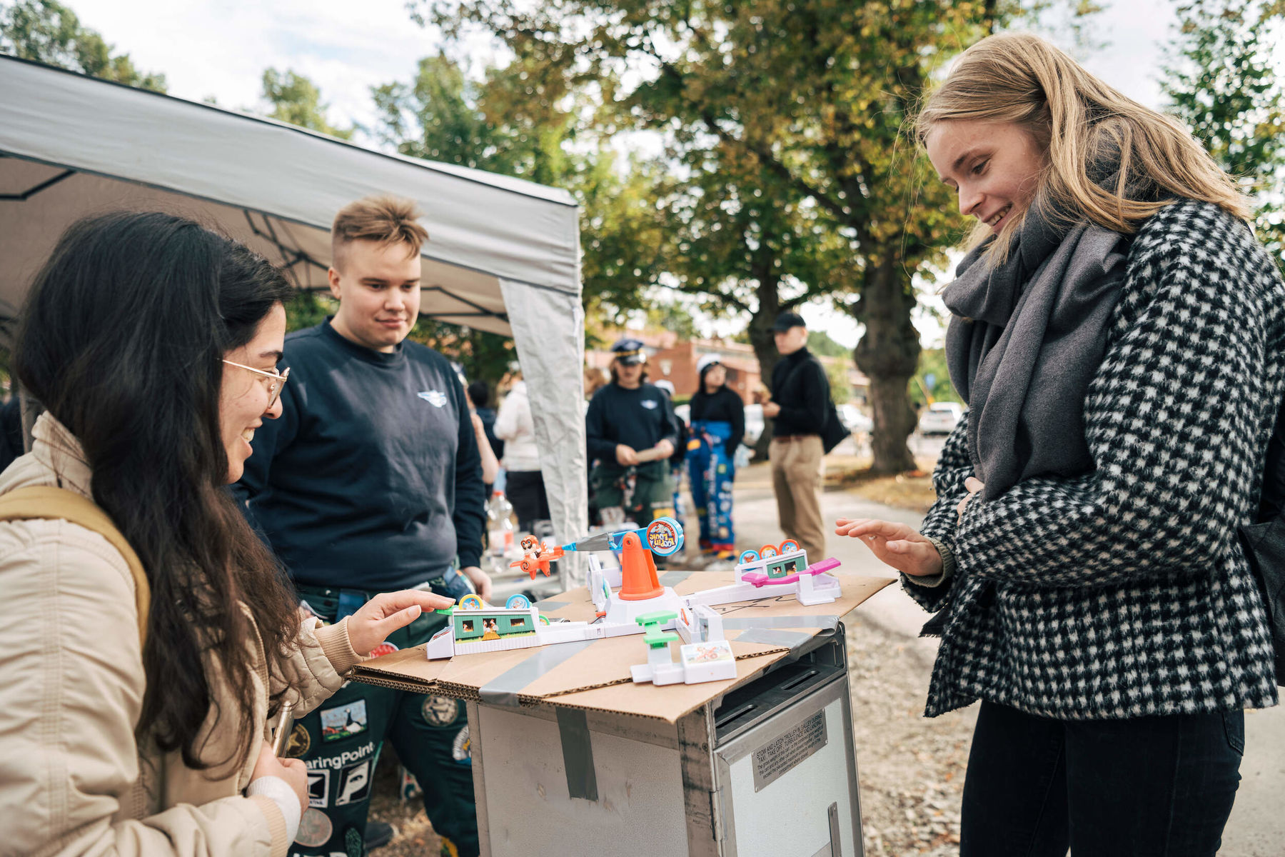 Three people playing with miniatures in Aalto Party