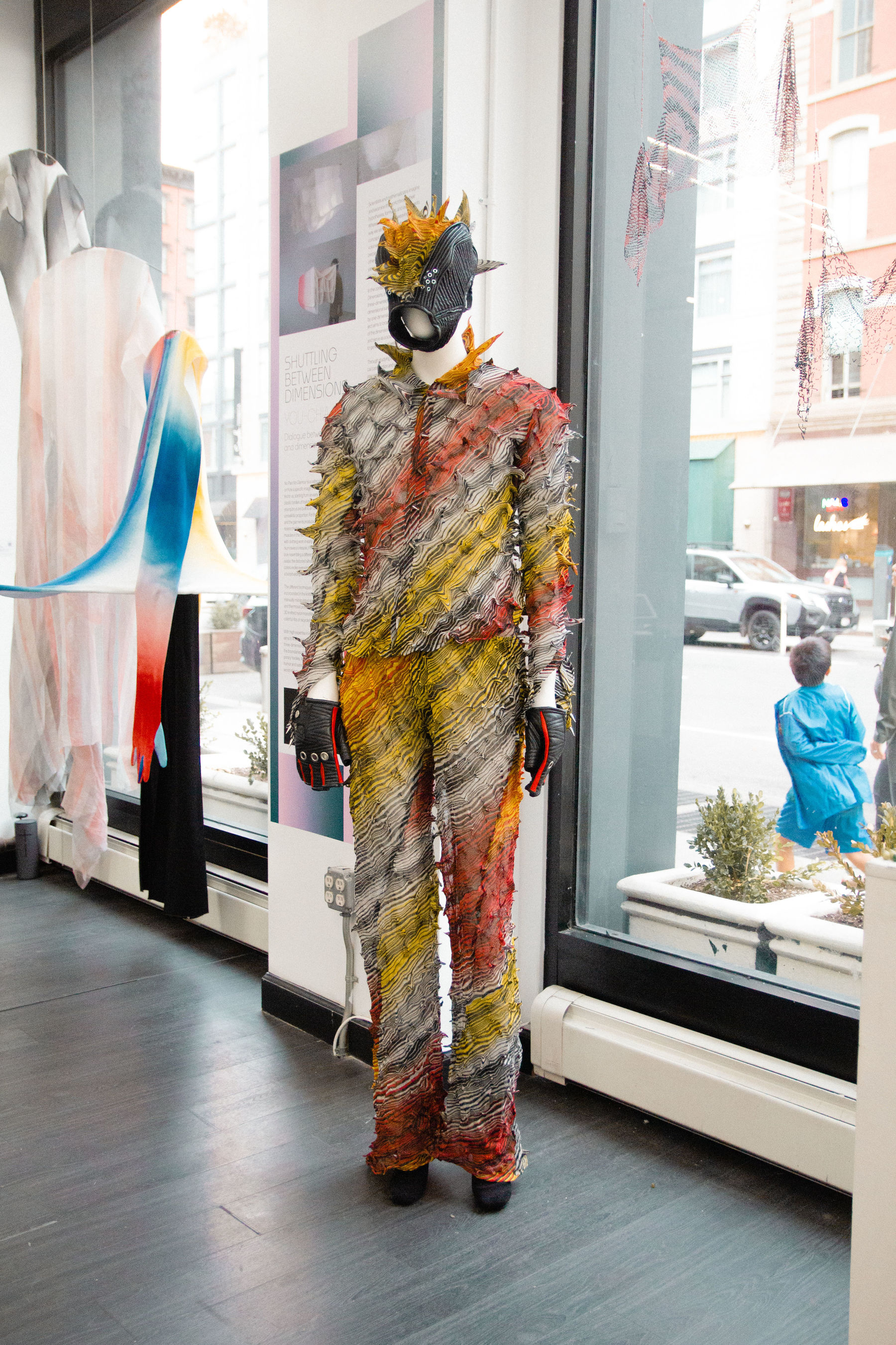 A very colourful garment on display by the window in the gallery in New York