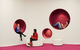 People sitting in round holes in walls. Photo by Unto Rautio / Aalto University.