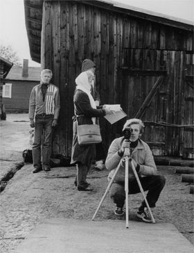 four people and camera in black and white country setting