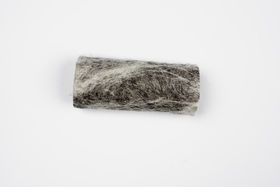 a piece of hardened black and white coloured wool