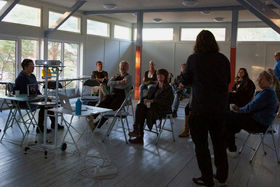 Workshop participants sit in Hietsun Paviljonki at the closing event.