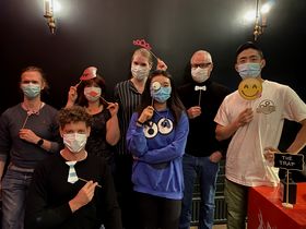 Group of people wearing masks upon attending a group event room escape.
