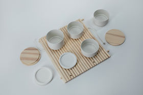 A set of wooden and ceramic kitchenware objects on wooden surface