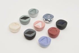 a set of small colourful ceramic containers