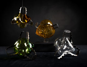 four glass pieces that are wrapped inside a metal structure with dark background