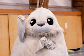 White seal mascot waving happily