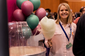 Woman with cotton candy smiling