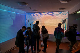 Students in front of the interactive digital mural in Space 21.