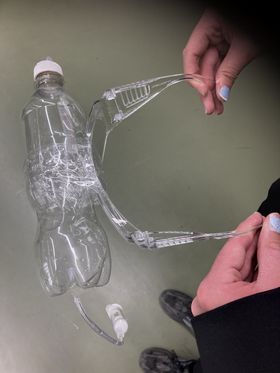 Water bottle taped onto plastic glasses.