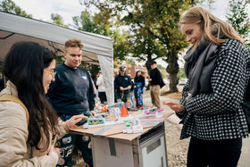 Three people playing with miniatures in Aalto Party