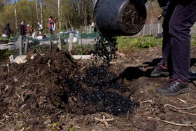 adding biochar to the soil in a community garden
