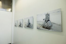Pictures hanging on the wall, with images of a child in an icebreaker outfit ice fishing.