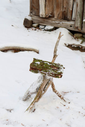 Snow in the background: A wooden sculpture made of pieces found in nature