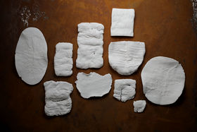 A collection of white clay objects of different shapes and textures