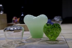 Two green glass objects and one clear one