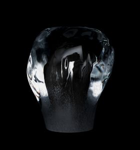 Bulbous, clear glass sculpture against a black background