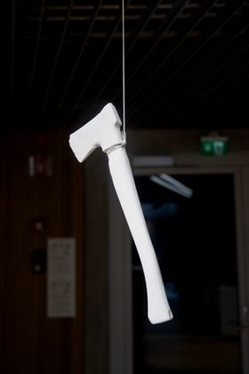 A white axe suspended from the ceiling 