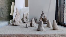 A collection of clay sketches resembling trees and mountains
