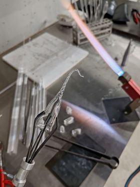 In the glass workshop - heating up and twisting glass with a torch