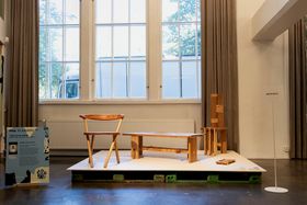 A wooden scandinavian looking chair, bench and another more sculptural chair