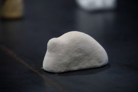 A bulbous ceramic object with a fuzzy texture