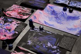 A collection of writings and pink, red, purple, black paintings on a black background