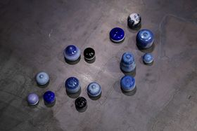 A collection of bulbous ceramic objects glazed in various shades of blue