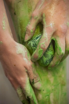 Closeup of the green algae foamy soap and hands using it