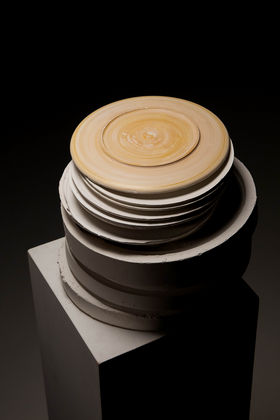 A stack of plaster moulds and plates, one on top the other