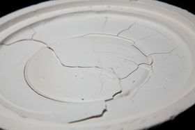 A cracked slip casted plate in a plaster mould