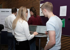 Young people looking some information together over a computer