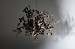 a hanging sculpture made of wooden parts and metal wire