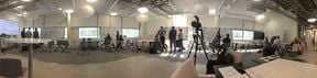 INUSE transition arena workshop - panorama of indoor space with groups discussing around whiteboards