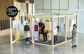 People gathering around a wooden structure as part of an exhibition in Väre building lobby.