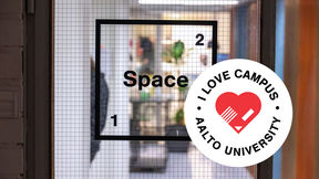 A view through the door of Space 21 with their logo in view. I love campus logo badge in the lower right corner.