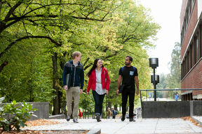 Aalto University students walking at campus on summer