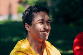 Header photo of close-up photo of a student in yellow t-shirt.
