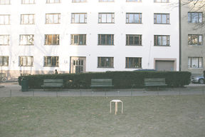 Wooden stool in front of a residential building