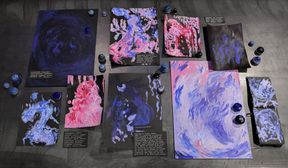 A collection of writings and paintings laid out on a black background