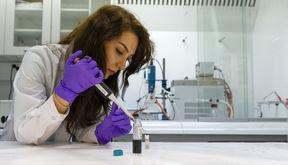 Doctoral student Fatemeh Davodi is applying drops of ink containing catalyst on an electrode, which will be attached to a measuring instrument. Photo: Glen Forde/Aalto Energy Platform